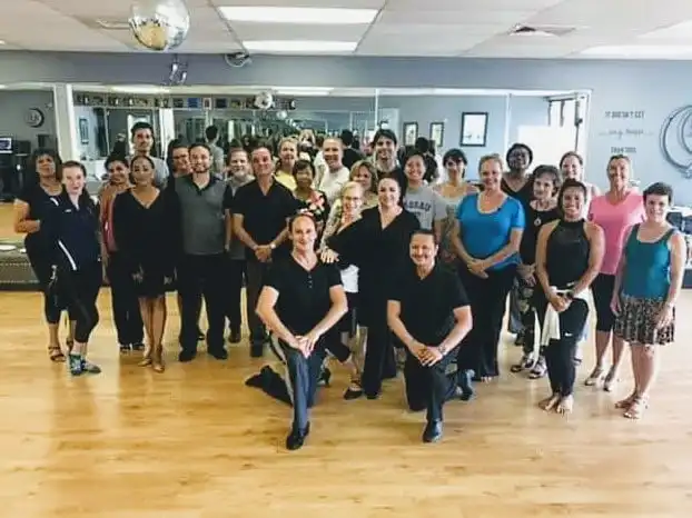 Dance studio class and staff